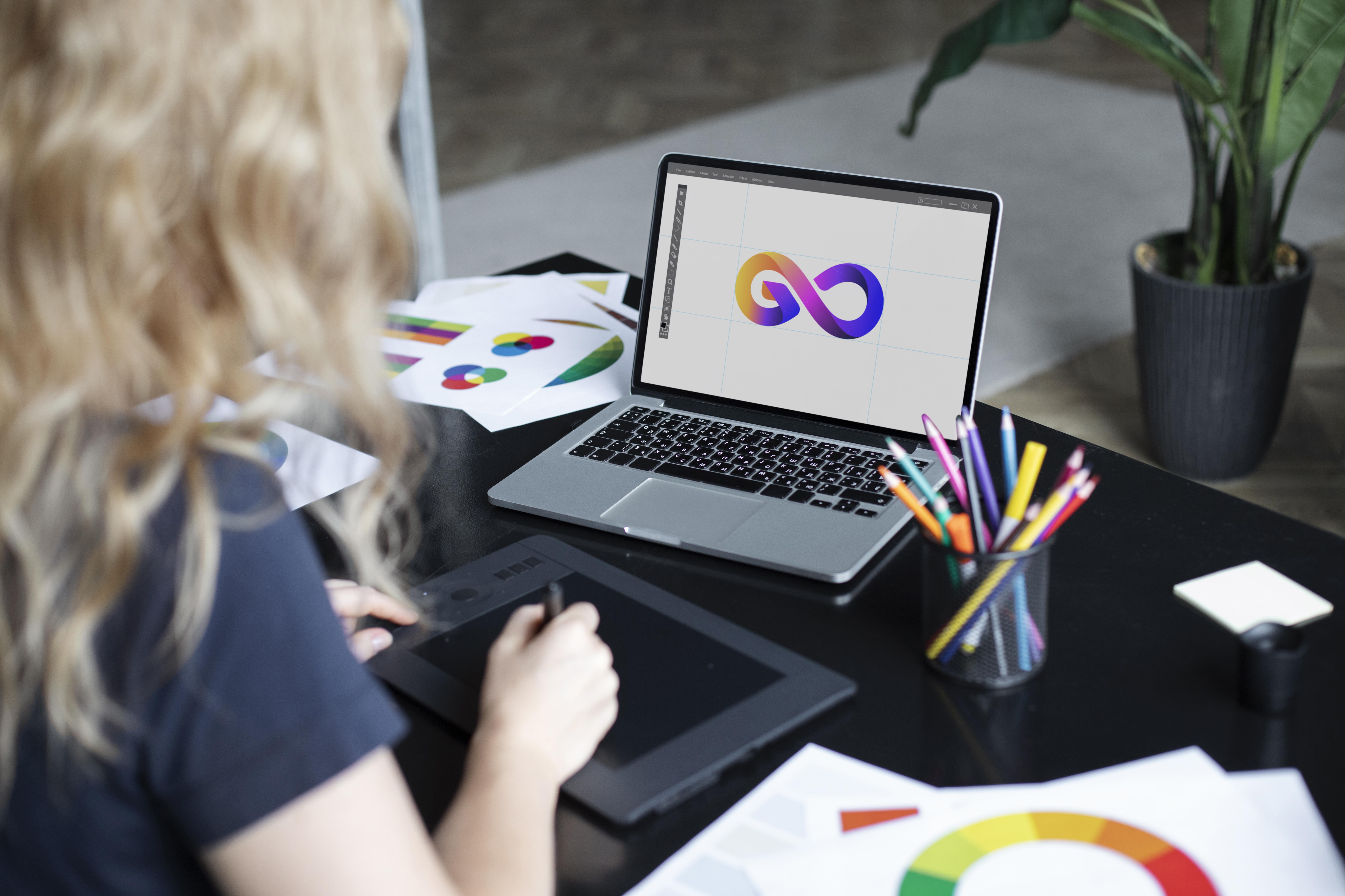 female-logo-designer-working-her-tablet-connected-laptop